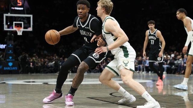 E.J. Liddell #9 of the Brooklyn Nets dribbles the ball against AJ Green #20 of the Milwaukee Bucks during the first quarter at Barclays Center on April 07, 2026 in New York City. 