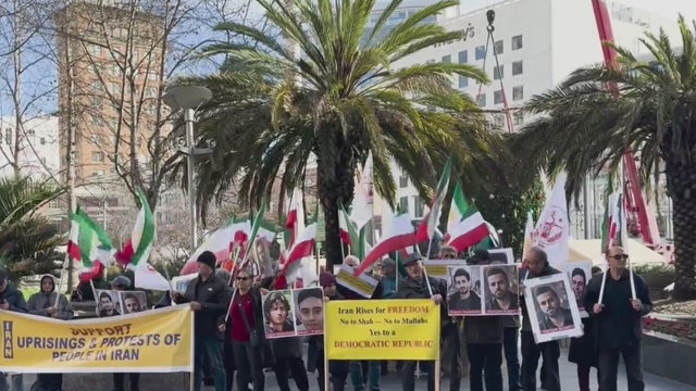 A crowd of people holding signs and banners 