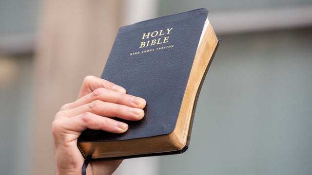 A worshipper holds up a Holy Bible during the march 