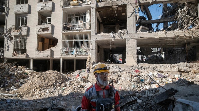 A rescue team member of the Iranian Red Crescent Society stands among the ruins of buildings in eastern Tehran, Iran, on April 9, 2026. 