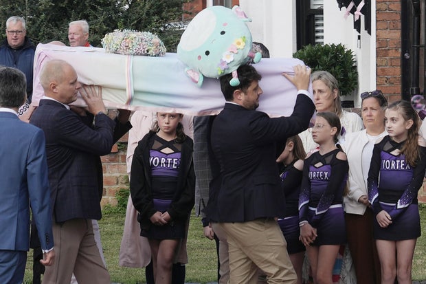 Mourners look on as the coffin is carried into church for a celebration of Elsie Dot Stancombe at St. John's Church, Aug. 23, 2024, in Birkdale, England. 