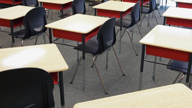 Desks and chairs in empty classroom 