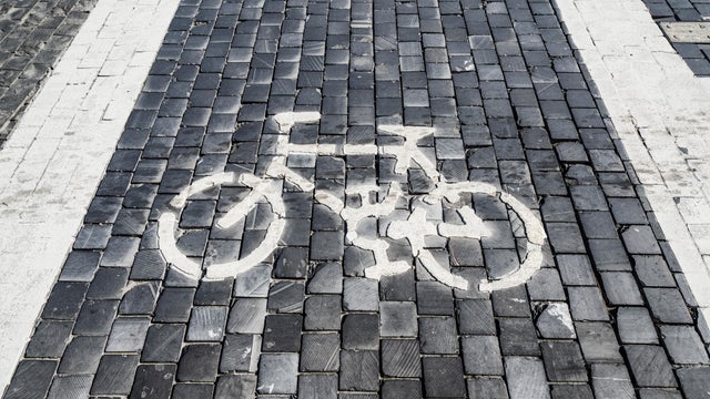 High Angle View Of Bicycle Lane Sign On Road 