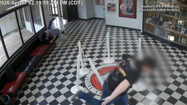 Newly released surveillance video shows Kirk Moore, the principal at Pauls Valley High School in Oklahoma, tackling a gunman in the school's lobby.