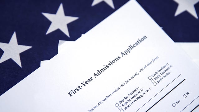First year admission application form with American flag in the backdrop. Studying abroad concept with close up of admission form 