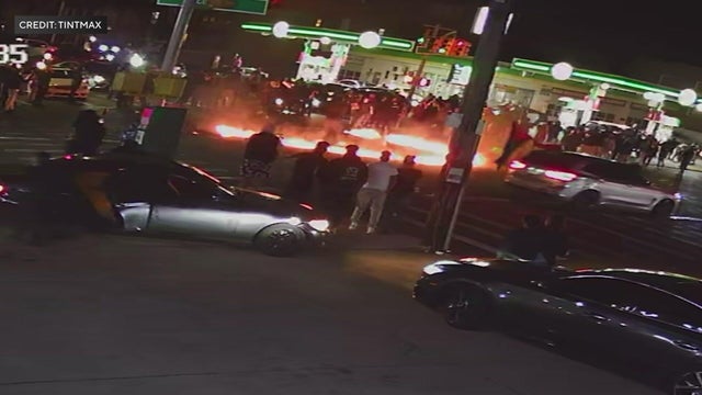 A ring of fire in the middle of an intersection with pedestrians and drivers 