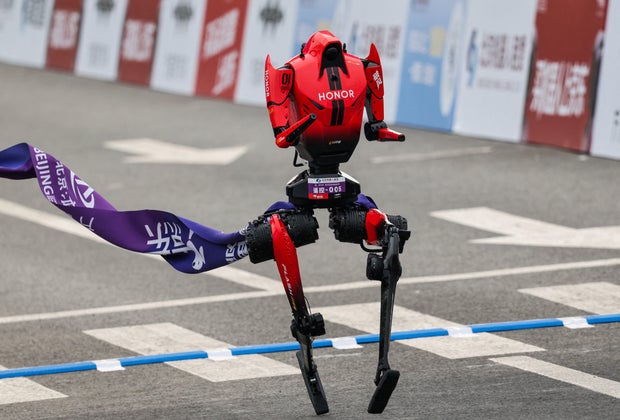 A Lightning humanoid robot by Honor crosses the finish line of the second Beijing E-Town Half Marathon and Humanoid Robot Half Marathon in Beijing, China, April 19, 2026. 