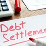 Debt Settlement handwritten on loan documents. 