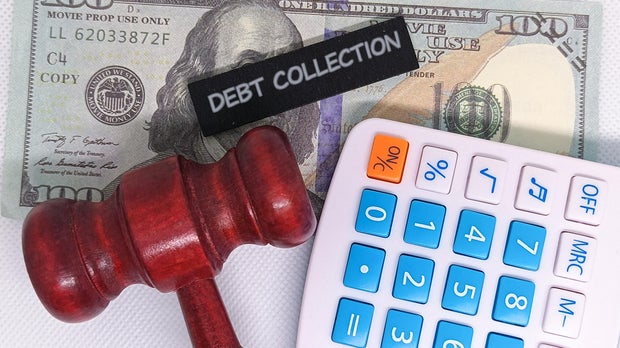 Debt collection concept with gavel, calculator and money 
