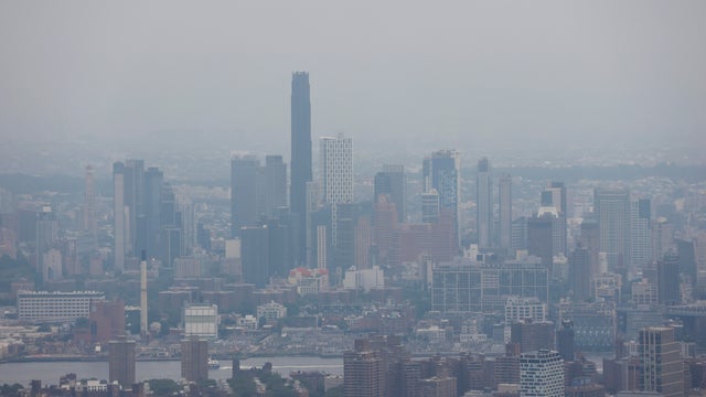 The view south to the Brooklyn skyline and the Brooklyn Tower is shrouded by a thick layer of smoke from Canadian wildfires, as seen from the 86th floor of the Empire State Building at sunset on August 5, 2025, in New York City. 