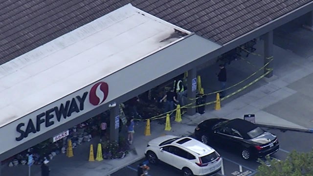 Yellow caution tape seen in front of a grocery store 