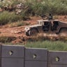 An Israeli armoured vehicle drives inside Lebanon, as seen from the Israeli side of the border with Lebanon 