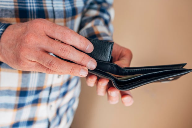 male hands holding an open wallet 