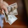 Close up Hand Squeeze  US Dollar Bills 