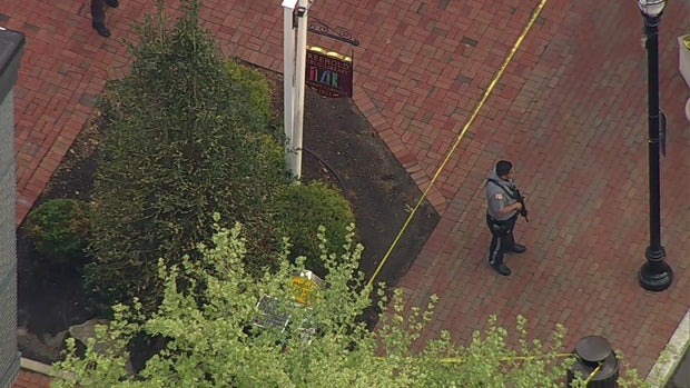 An officer and crime scene tape outside the Freehold Public Library 