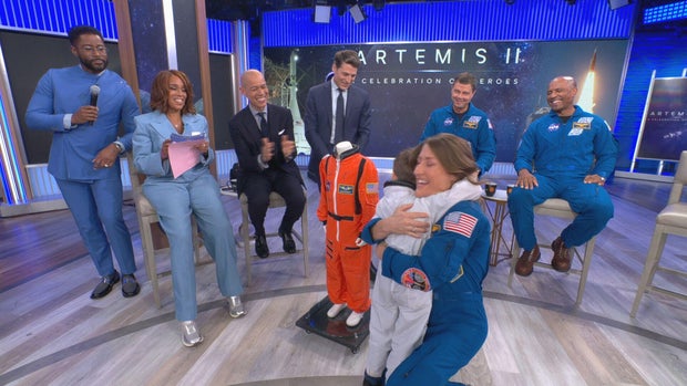 Five-year-old Jack hugs Artemis II mission specialist Christina Koch after he was given a spacesuit May 1, 2026. 