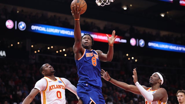 Og Anunoby #8 of the New York Knicks shoots the ball in front of Onyeka Okongwu #17 and Jonathan Kuminga #0 of the Atlanta Hawks during the first half in Game Six of the First Round of the NBA Eastern Conference Playoffs at State Farm Arena on April 30, 2026 in Atlanta, Georgia. 