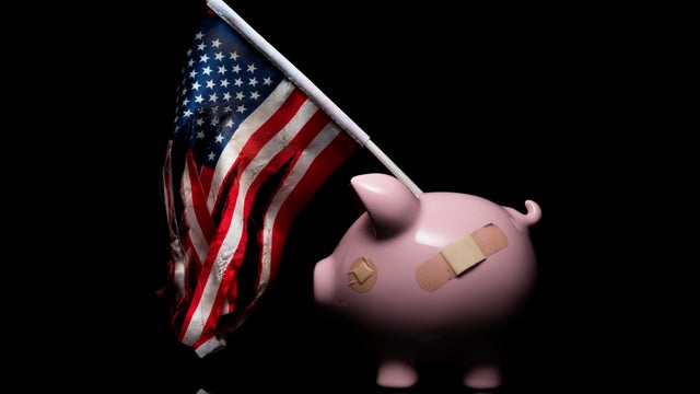 Piggy Bank with a Torn American Flag 