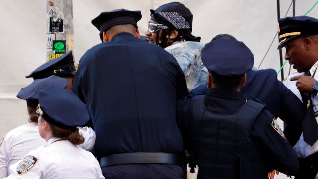 A man is detained by NYPD officers after he tried to break into the red carpet of the 2026 Met Gala celebrating "Costume Art" at the Metropolitan Museum of Art, in New York, on May 4, 2026. 