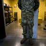 In this photo reviewed by U.S. military officials, a U.S. soldier stands between two cells, one used as a library and the other a gym, inside the Camp VI detention facility at the Guantanamo Bay U.S. naval base in Cuba on June 6, 2018. 
