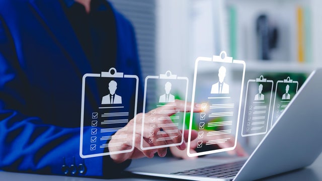 Recruitment and candidate selection concept. Businessman interacts with digital interface with multiple candidate profiles on laptop. Represents online recruitment, HR technology, hiring process, 
