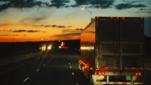 Blurred images of trucks driving at night 