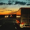 Blurred images of trucks driving at night 