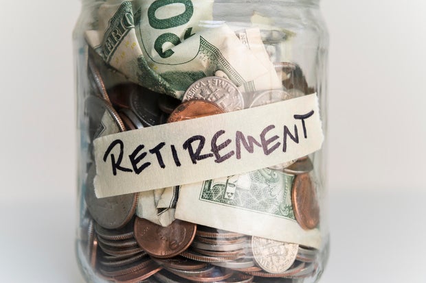Money in jar labeled 'retirement' 