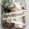 Money in jar labeled 'retirement' 