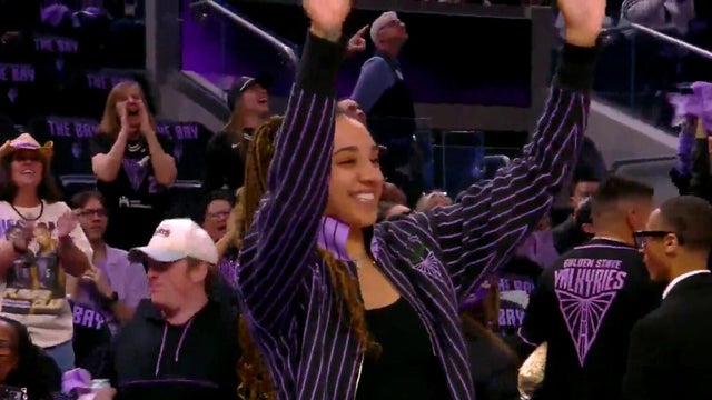a professional WNBA player waving at fans 