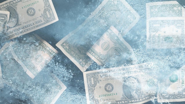 US dollar bills frozen in ice 