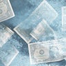 US dollar bills frozen in ice 