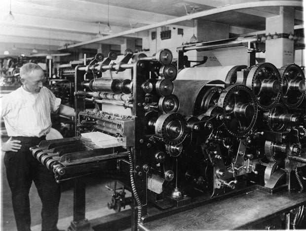 A printer watches over a printing press at what was then the Government Printing Office in Washington, D.C., in the early 20th century. 