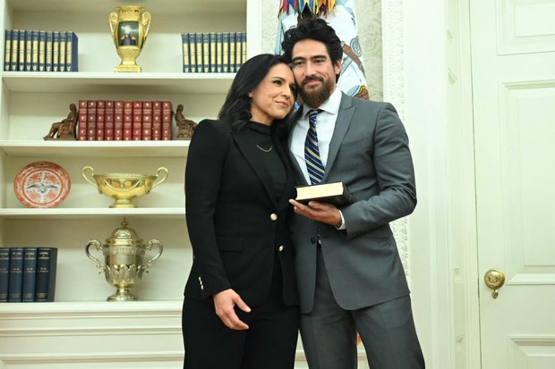 Tulsi Gabbard and her husband Abraham Williams hug before she is sworn in as director of national intelligence in the Oval Office on Feb. 12, 2025.
