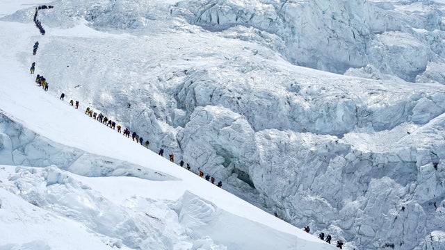 FILE PHOTO: Climbers walk in a long queue as they head to summit Mount Everest in the Solukhumbu district, also known as the Everest region 