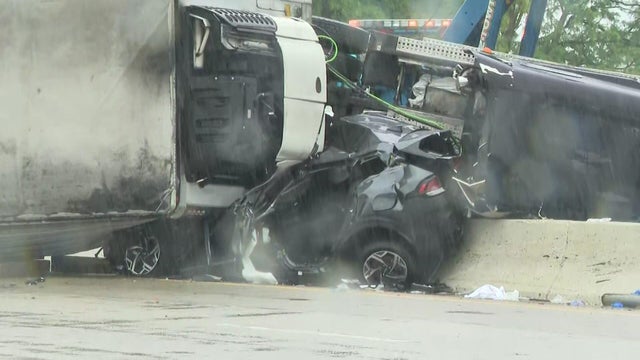 Tractor-trailer overturned onto SUV and concrete barrier 