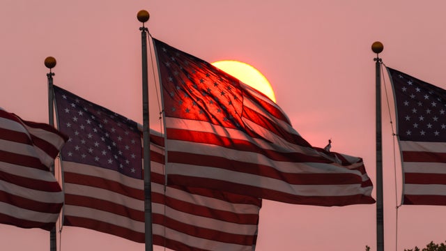 American flags waving against a dramatic sunset sky, symbolizing patriotism and freedom,Jersey City,United States,USA,Liberty State Park 