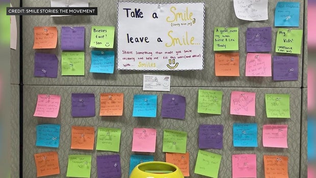 Post-it notes on a cubicle wall