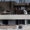 Law enforcement work on the site of an explosion at a residential block of flats following a drone hit in Galati 