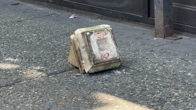 Piece of debris from building on sidewalk 