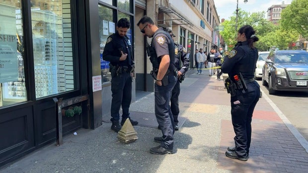 Piece of debris from building on sidewalk with police