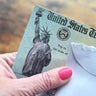 Female holding a check from the United States Treasury 