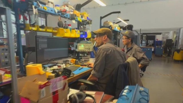 two people sitting at a work desk 