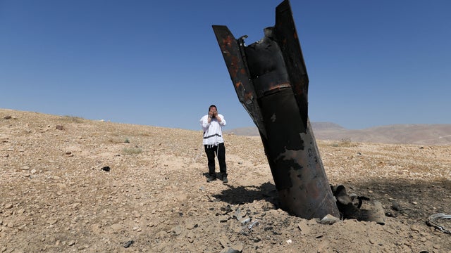 An Israeli ultra-Orthodox Jewish man reacts near a missile protruding from the ground following strikes from Iran in the central Israeli-occupied West Bank, June 8, 2026. 