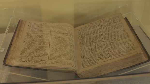 A Book of Common Prayer on display at the museum, some parts have a line drawn through them because they reference England or the royal family 