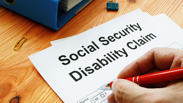 Man filling in Social Security Disability Claim. 