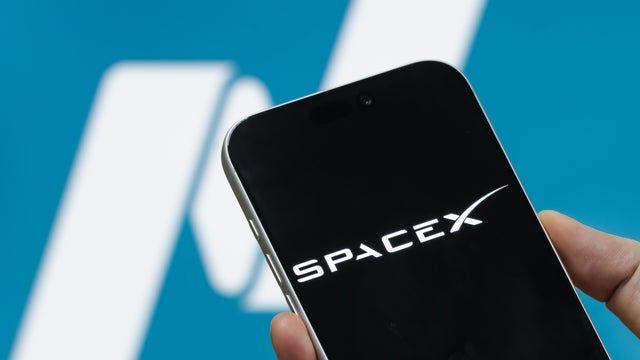 SpaceX Logo Displayed on Smartphone with Nasdaq Logo Ahead of Anticipated IPO 