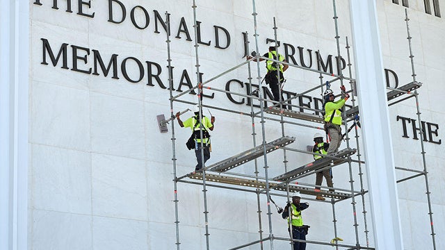 Workers stand on scaffolding outside the Kennedy Center on June 12, 2026, ahead of a deadline to remove President Trump's name from the building. 