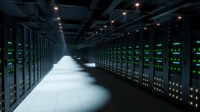 Server racks glowing in a modern data center expanding infinitely 