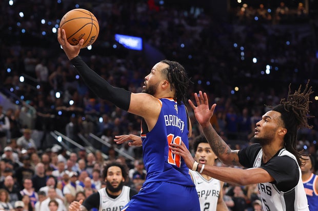 Jalen Brunson #11 of the New York Knicks shoots the ball past Stephon Castle #5 of the San Antonio Spurs during the fourth quarter in Game Five of the 2026 NBA Finals at Frost Bank Center on June 13, 2026 in San Antonio, Texas.